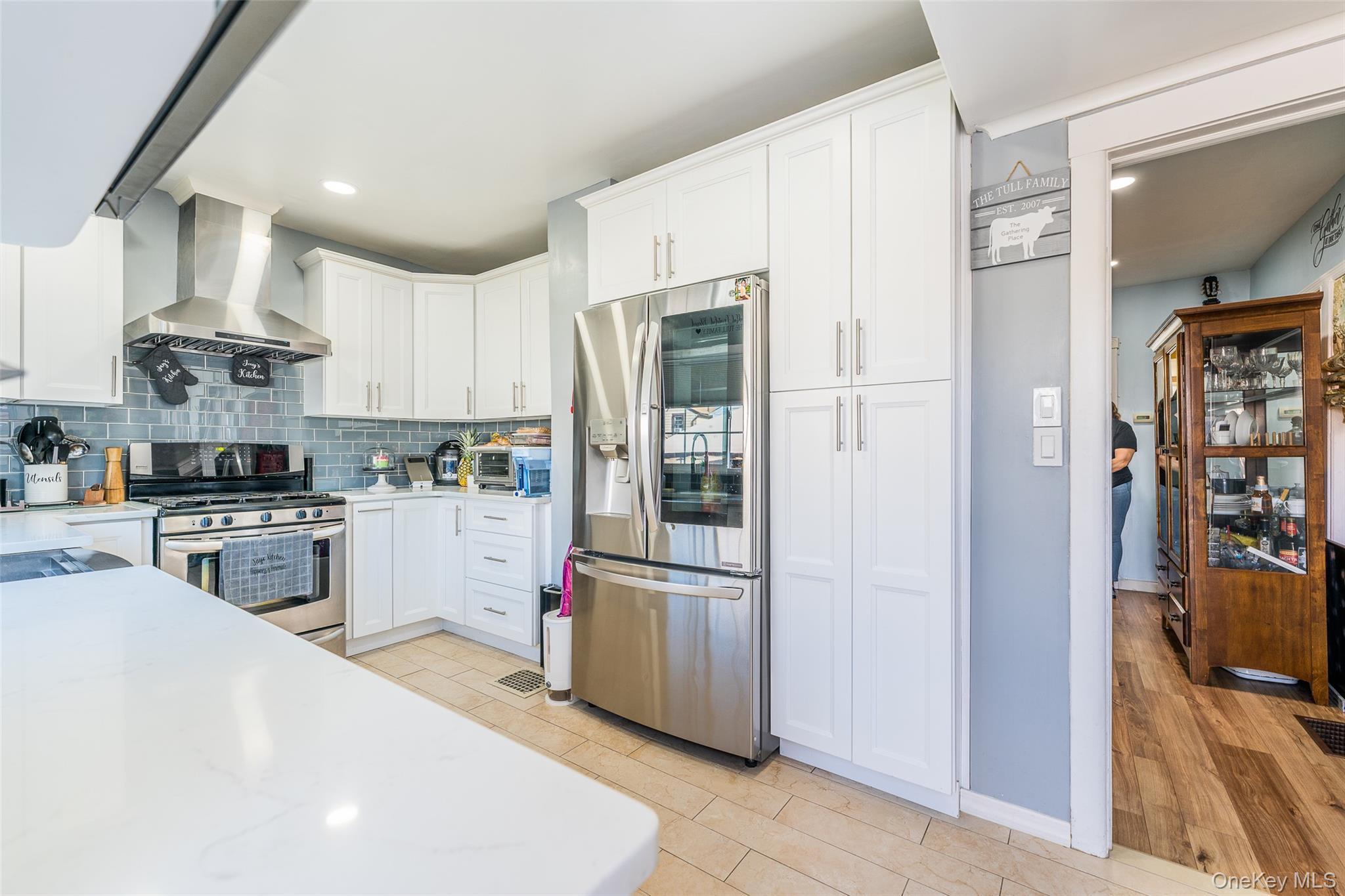 89-32 90th Street Queens, NY 11421 - Photo 4 of 33 Kitchen with stainless steel appliances, white cabinets, light stone counters, recessed lighting, and tasteful backsplash