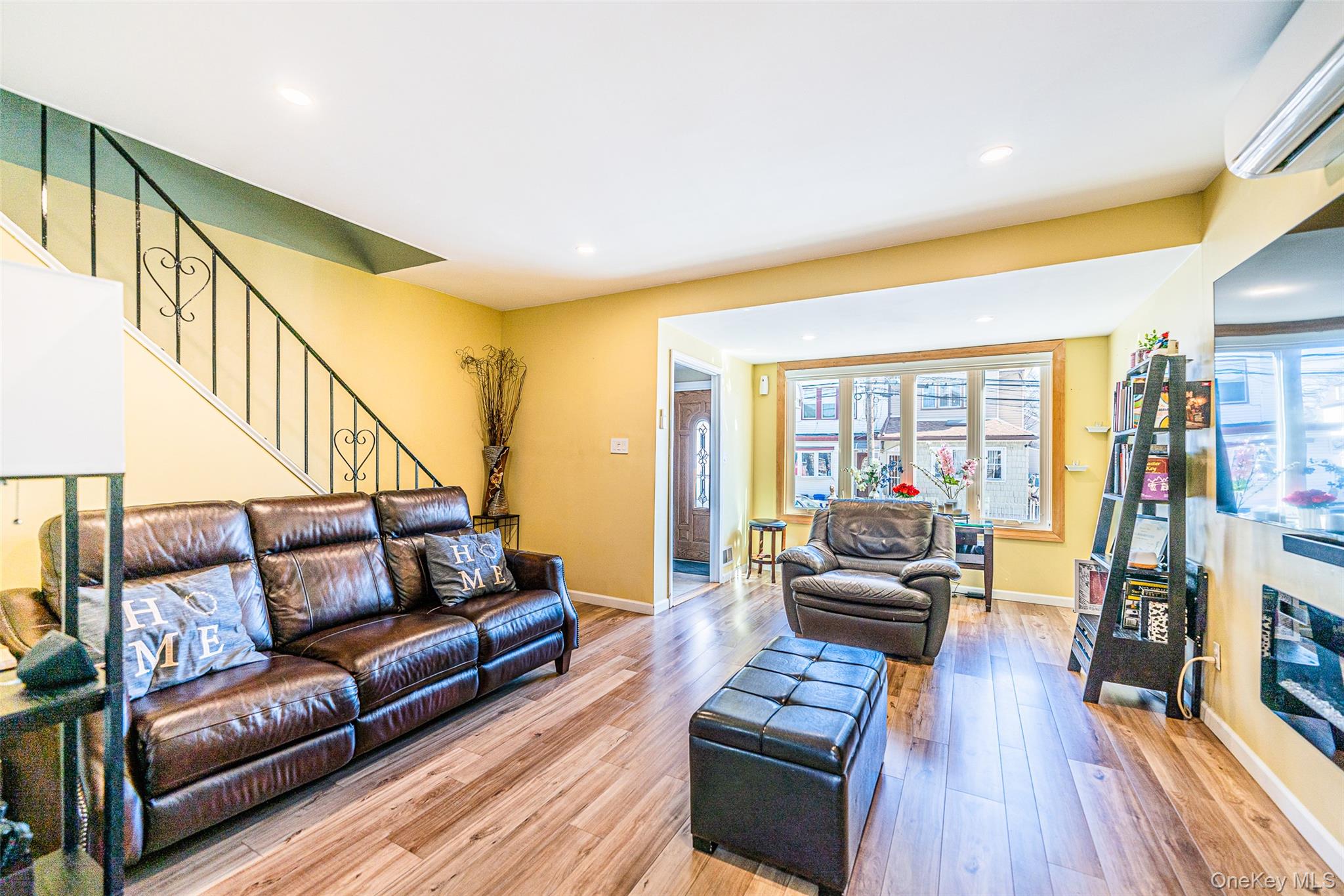 89-32 90th Street Queens, NY 11421 - Photo 7 of 33 Living room featuring light wood-style flooring, recessed lighting, and a glass covered fireplace
