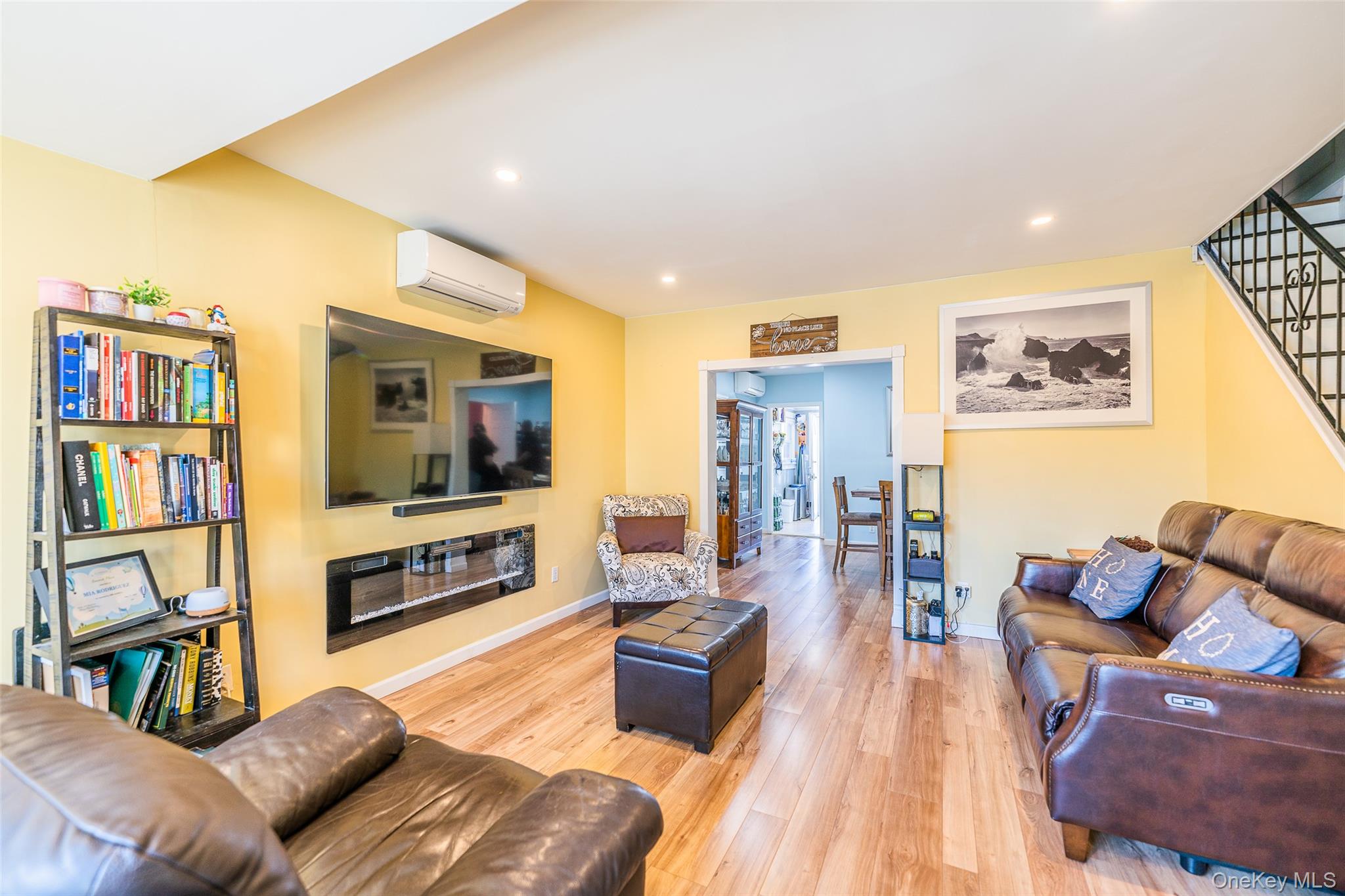 89-32 90th Street Queens, NY 11421 - Photo 9 of 33 Living room featuring a glass covered fireplace, light wood-style floors, and recessed lighting