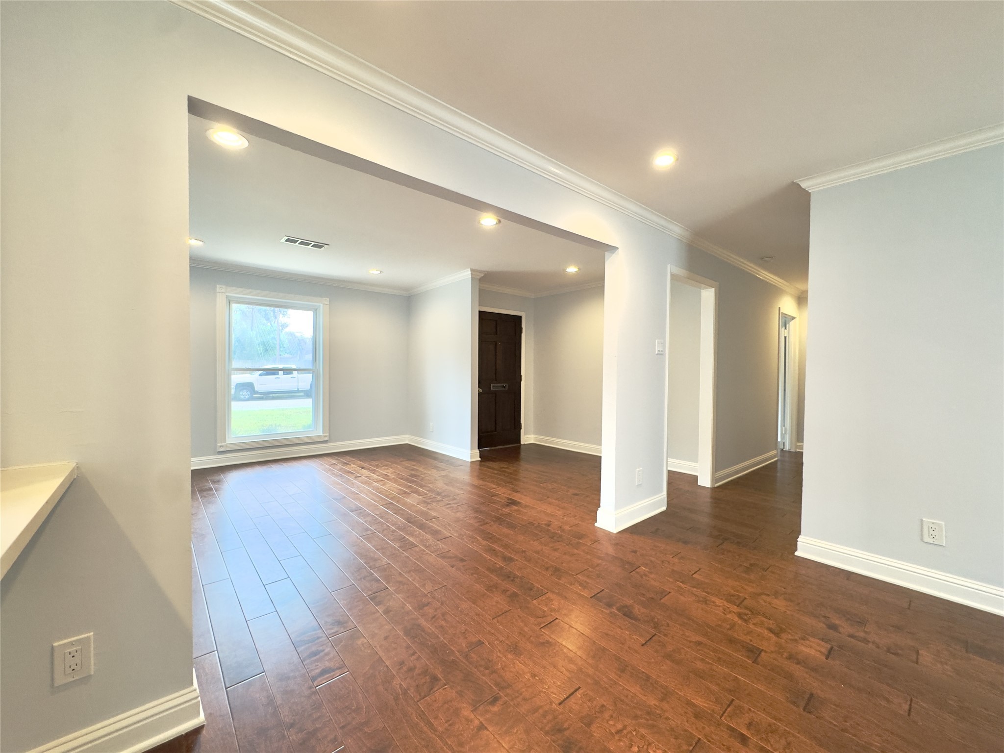 1415 Mapleton Drive Houston, TX 77043 - Photo 3 of 44 a view of an empty room with wooden floor and a window