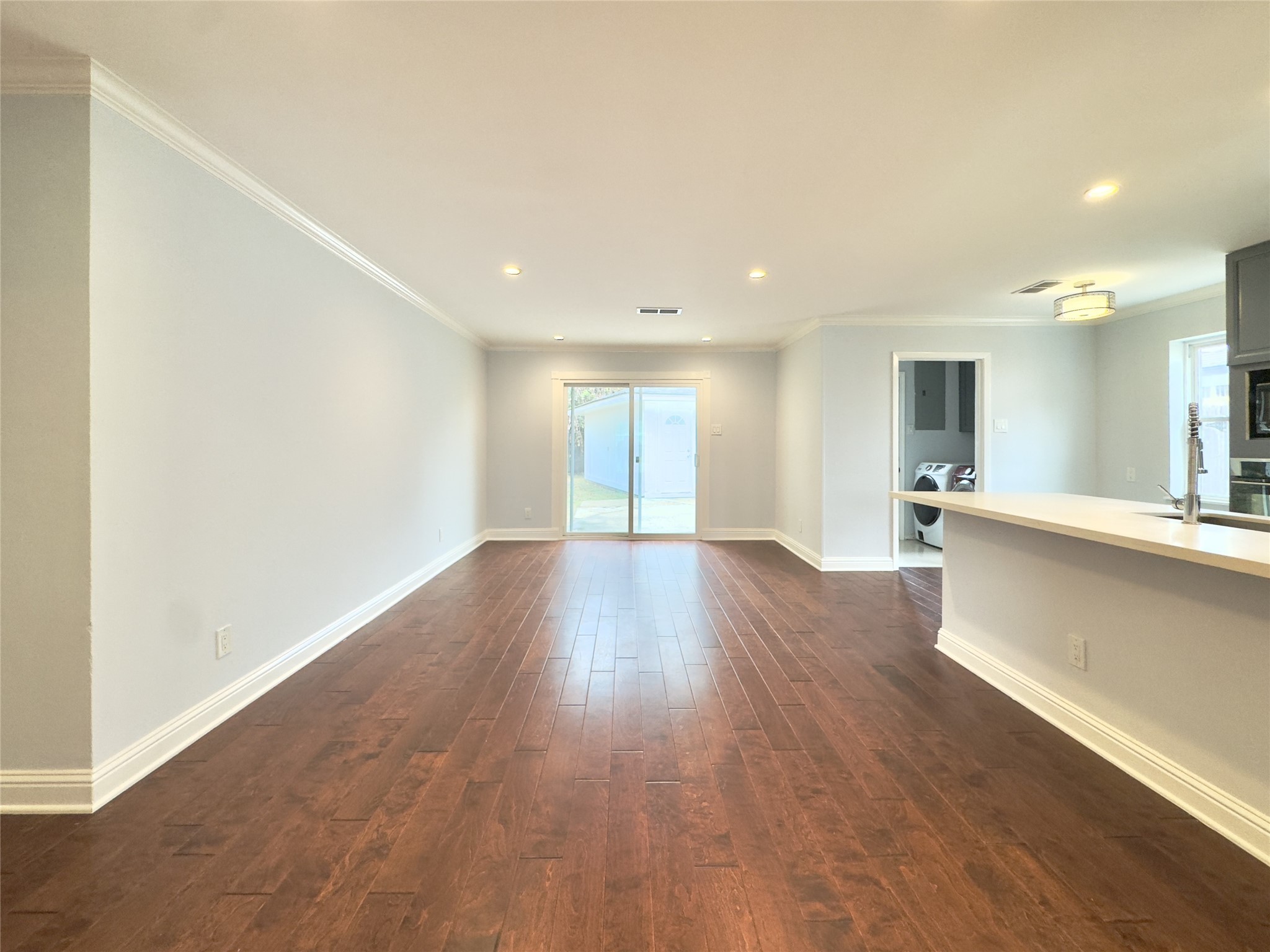 1415 Mapleton Drive Houston, TX 77043 - Photo 4 of 44 a view of a big room with wooden floor and windows