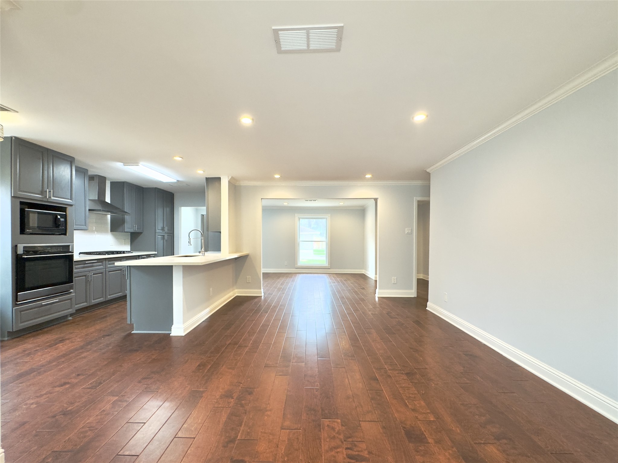 1415 Mapleton Drive Houston, TX 77043 - Photo 10 of 44 a view of kitchen with wooden floor and electronic appliances