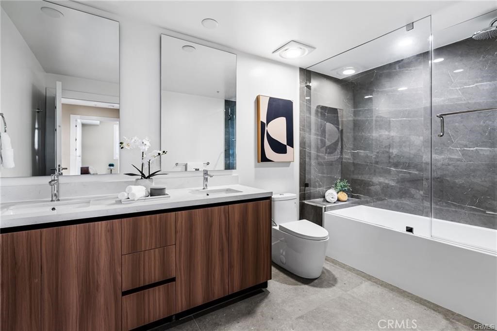 39 South Los Robles Avenue, Unit 6017 Pasadena, CA 91101 - Photo 12 of 22 a bathroom with a double vanity sink and a mirror