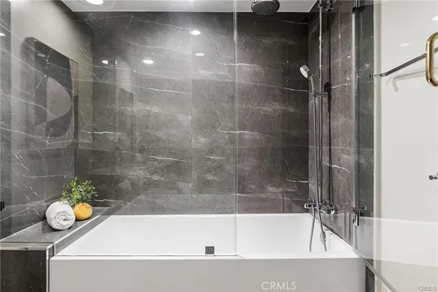 a bathroom with a tub and shower