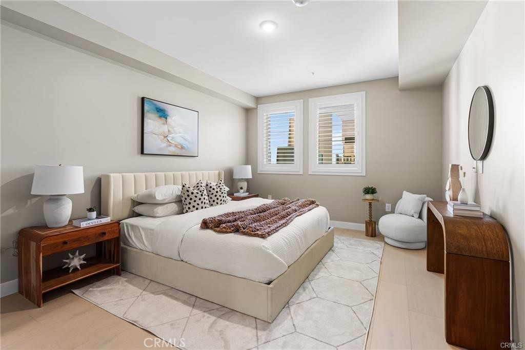 39 South Los Robles Avenue, Unit 6017 Pasadena, CA 91101 - Photo 15 of 22 a bedroom with a bed and wooden floor