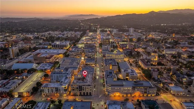 an aerial view of residential houses with city view