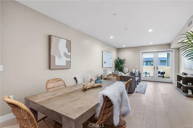 a view of a a dining room with furniture window and wooden floor