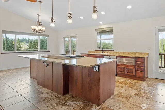 a kitchen with stainless steel appliances granite countertop a stove a sink and a refrigerator