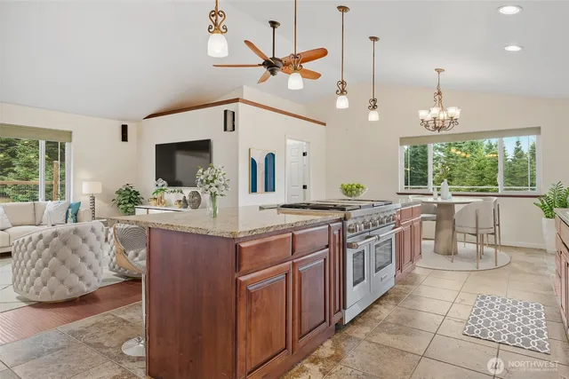 a kitchen with stainless steel appliances a sink a counter top space appliances and a large window