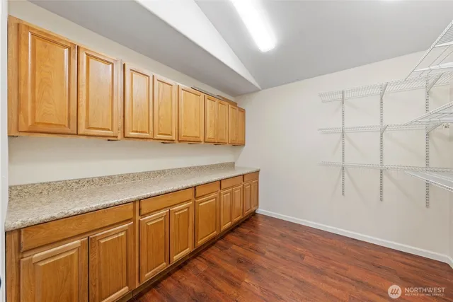 a view of a kitchen with wooden floor
