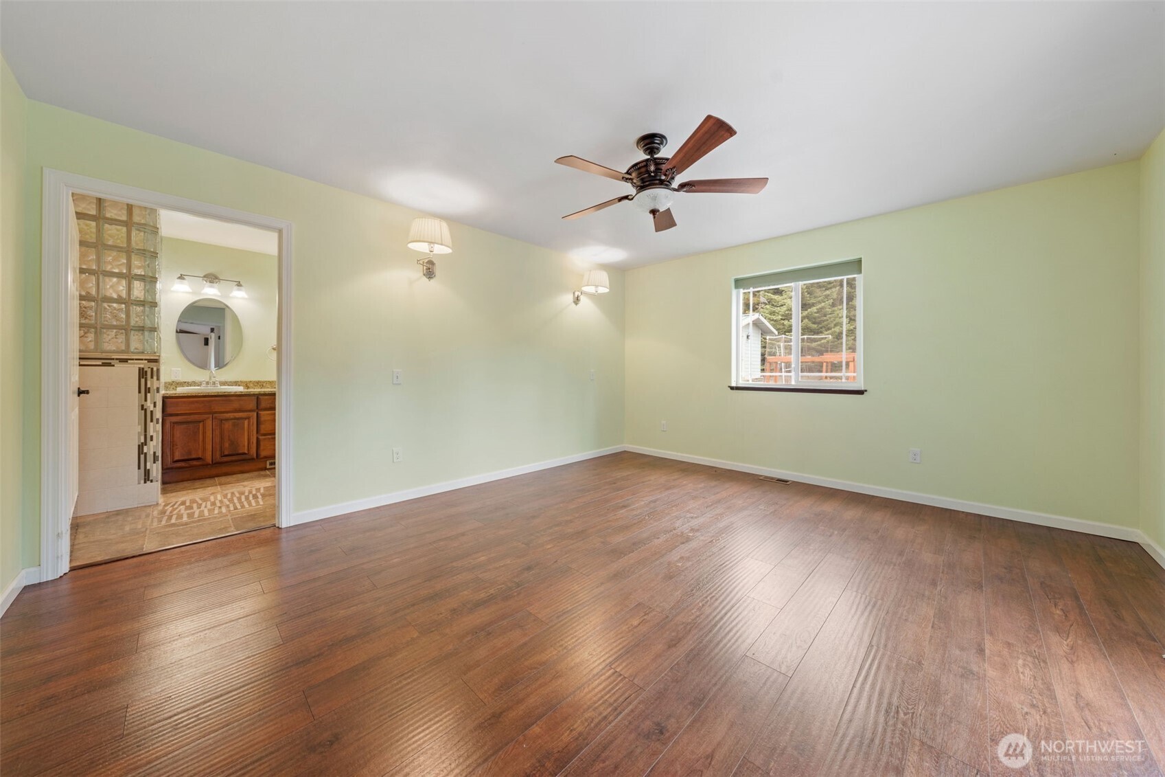 182-51 Burchett Road Onalaska, WA 98570 - Photo 14 of 29 a view of empty room with wooden floor and fan