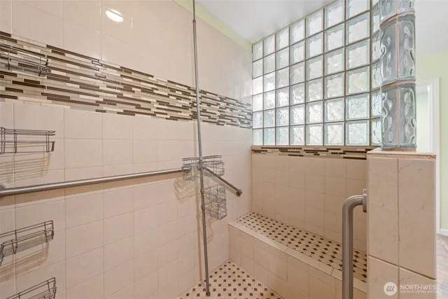 a bathroom with a shower and a window