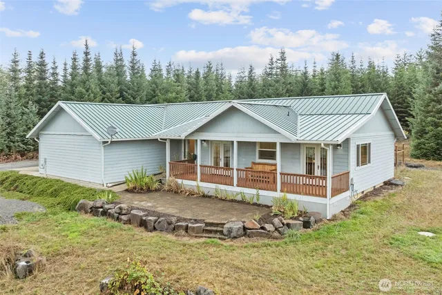 a view of a house with a yard balcony and sitting area