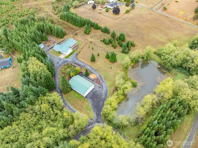 an aerial view of a house with a yard and lake view