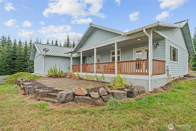 a view of a house with backyard and sitting area