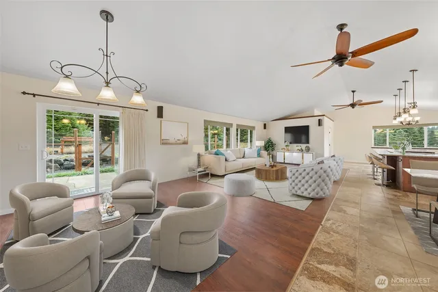 a living room with furniture and a chandelier