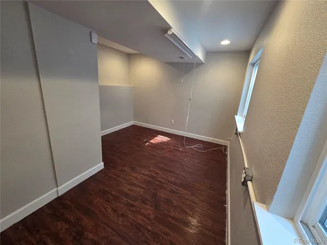 an empty room with wooden floor