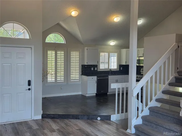 a view of entryway and hall with wooden floor