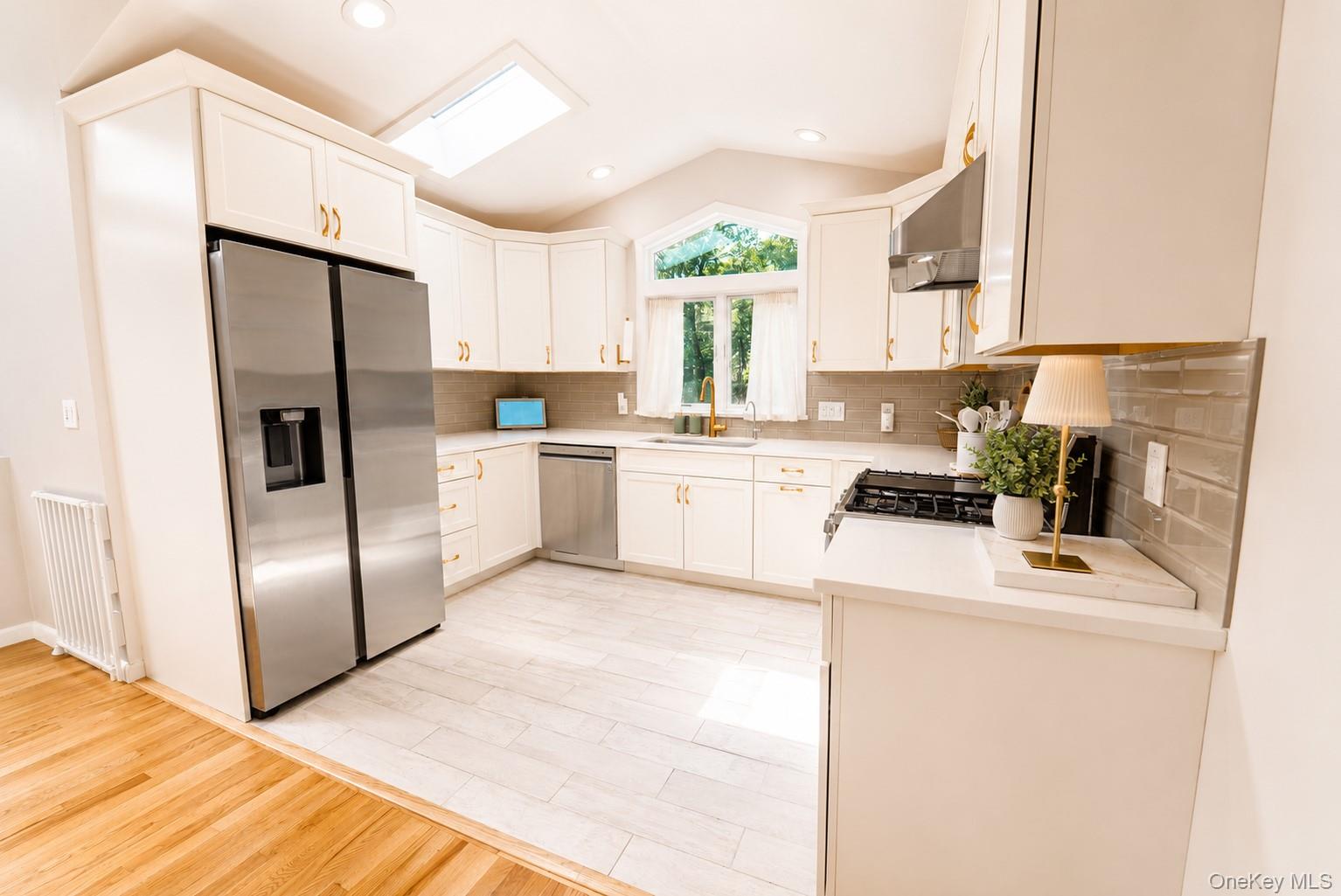 31 Pleasant Road Lake Peekskill, NY 10537 - Photo 16 of 41 Designed with both style and functionality in mind, the kitchen features durable tile flooring and recessed lighting and a skylight that beautifully illuminates the space, creating a bright and inviting atmosphere.