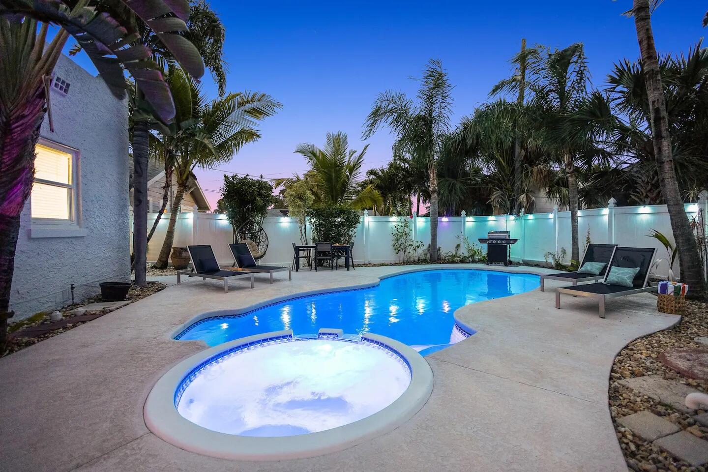 a swimming pool with outdoor seating yard and barbeque oven