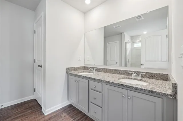 a bathroom with a granite countertop sink and a mirror
