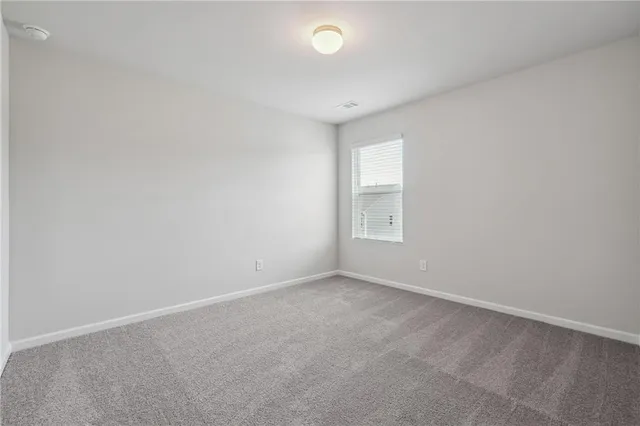 an empty room with a empty space and a window