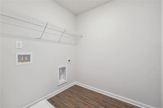 a view of a room with wooden floor and white walls