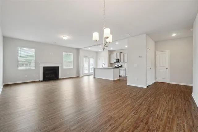 a view of a kitchen with wooden floor and a kitchen