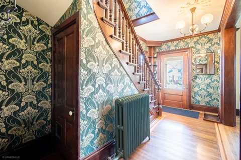 a view of entryway with wooden floor and door