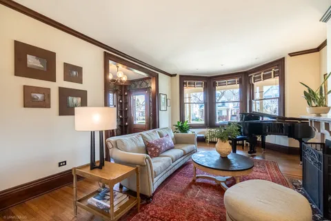 a living room with furniture a large window and a table