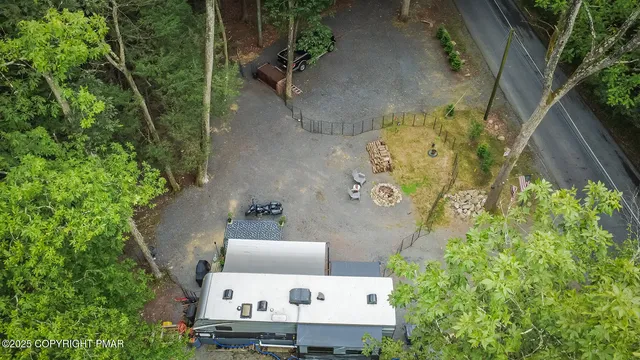 an aerial view of a house with a yard basket ball court