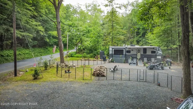 a view of a house with backyard and a patio