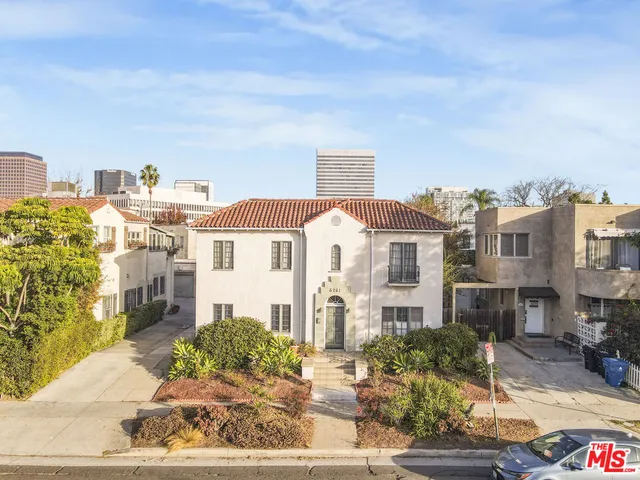 a front view of a residential apartment building with a yard