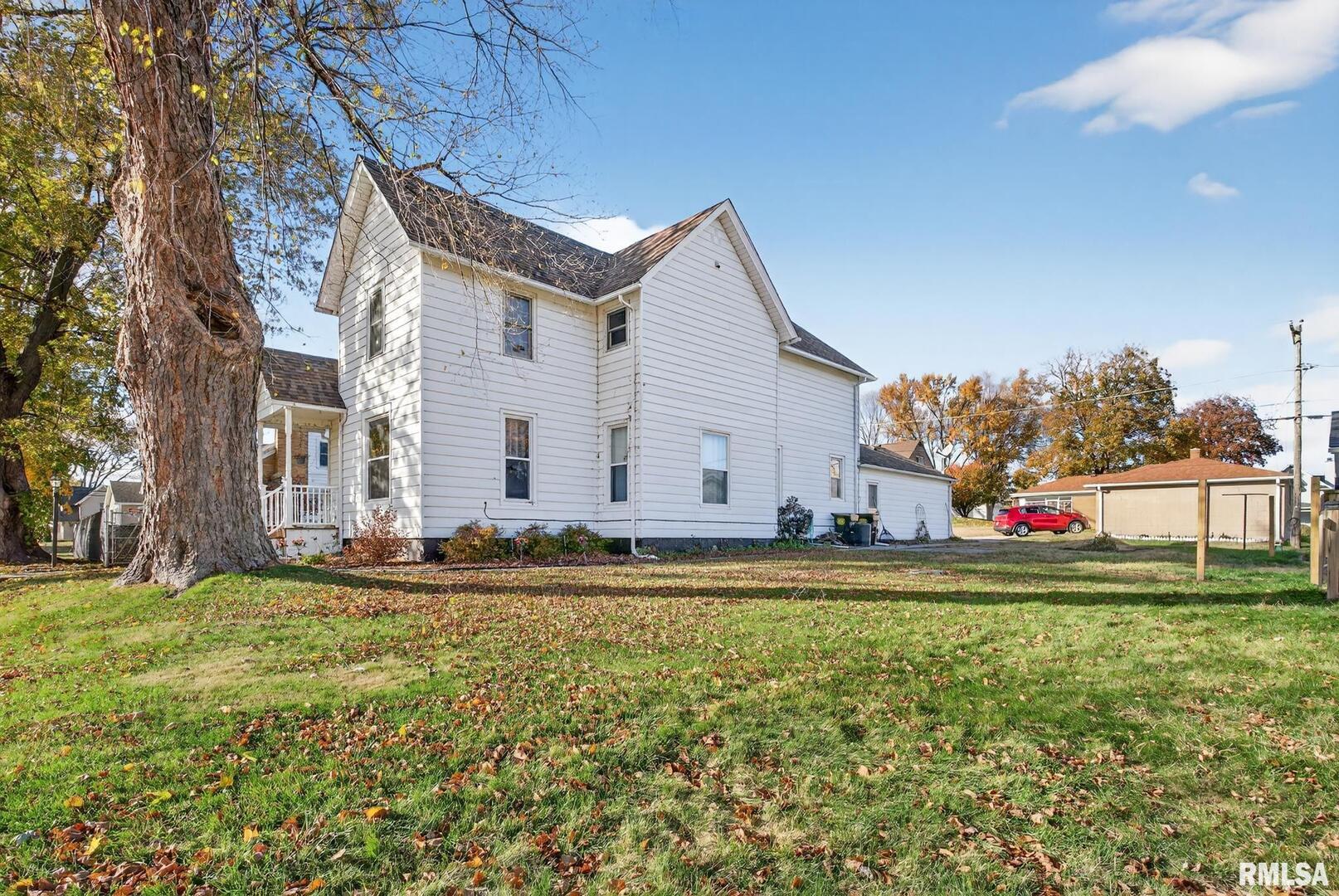 919 9th Avenue Fulton, IL 61252 - Photo 16 of 54 a view of a house with a big yard and large trees