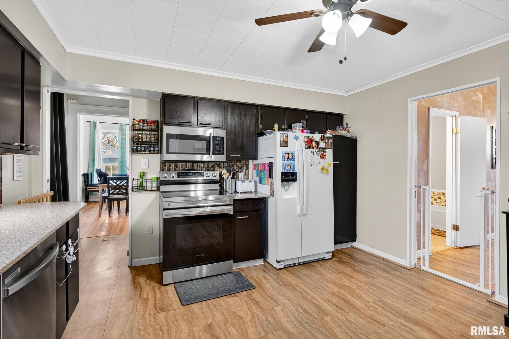 919 9th Avenue Fulton, IL 61252 - Photo 32 of 54 a kitchen with stainless steel appliances granite countertop a refrigerator and a stove top oven