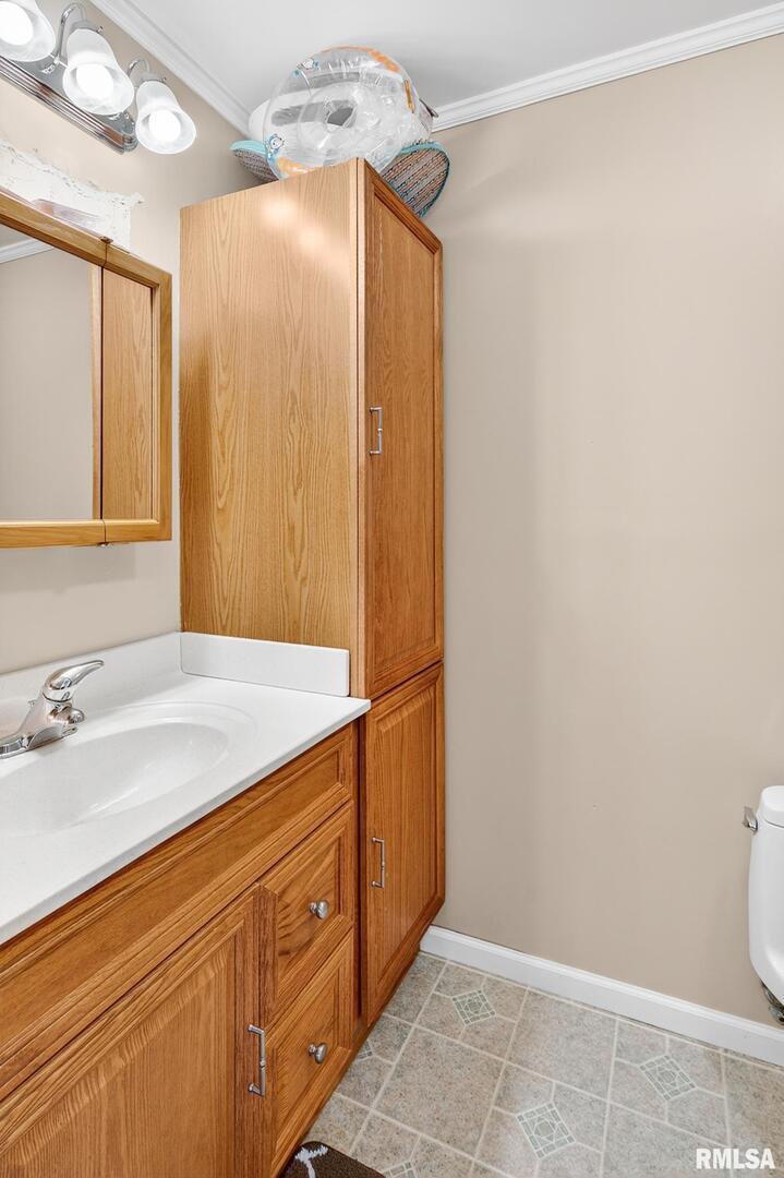 919 9th Avenue Fulton, IL 61252 - Photo 35 of 54 a bathroom with a granite countertop sink and a mirror