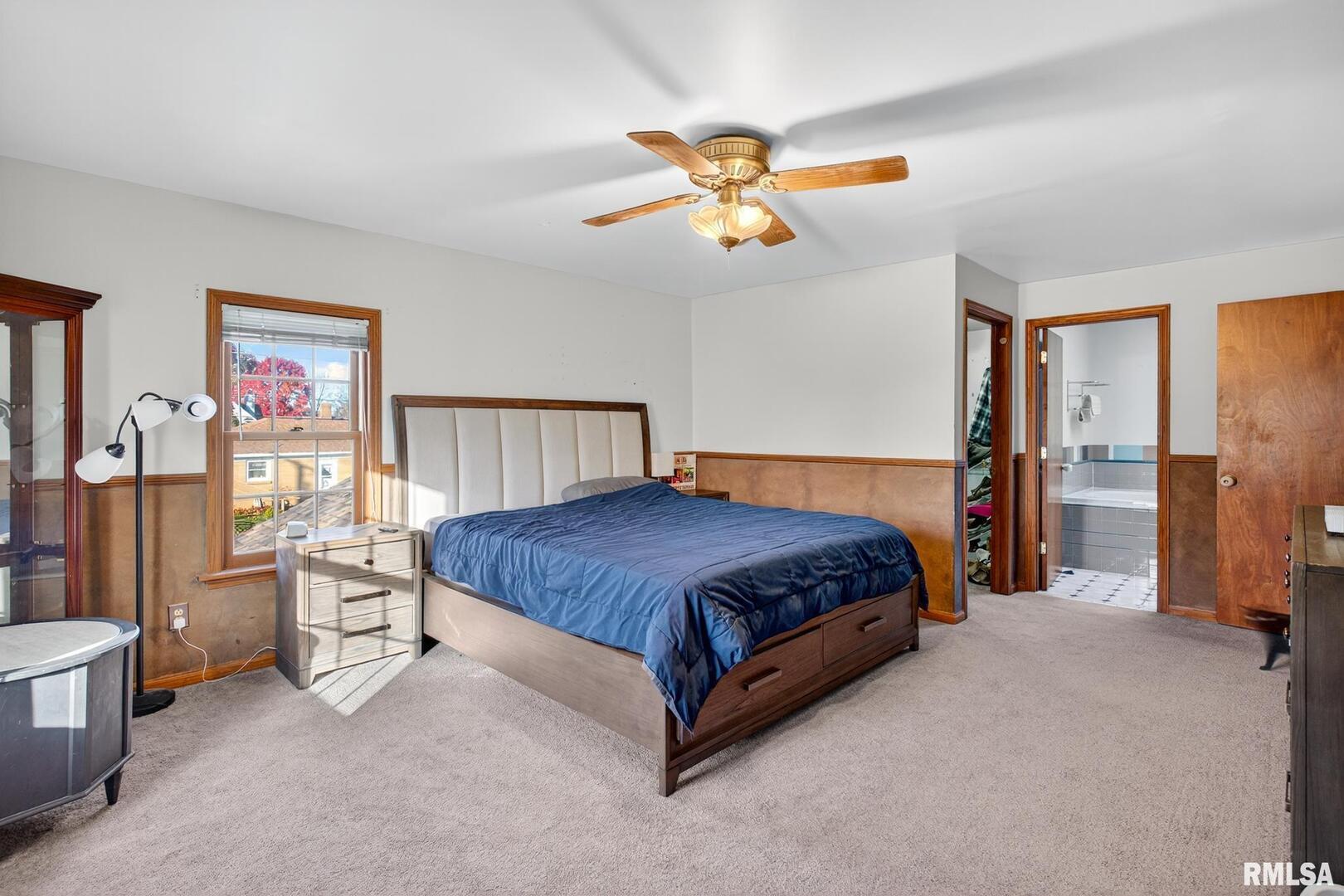 919 9th Avenue Fulton, IL 61252 - Photo 39 of 54 a bedroom with a bed and a chandelier