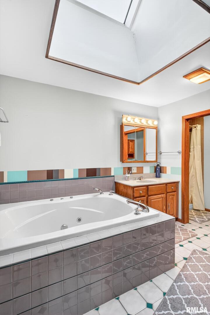 919 9th Avenue Fulton, IL 61252 - Photo 41 of 54 a bathroom with a tub a sink and a mirror