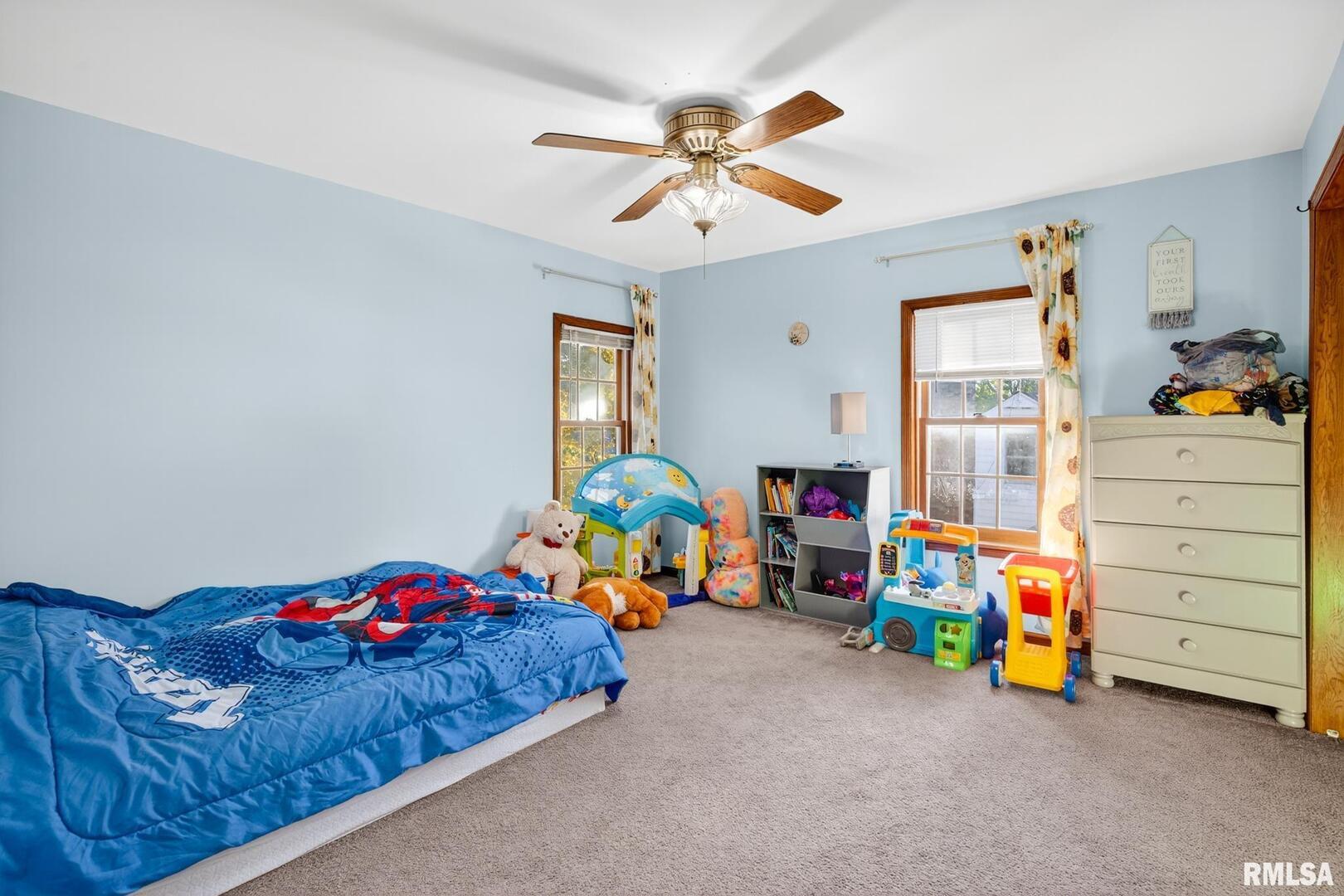 919 9th Avenue Fulton, IL 61252 - Photo 49 of 54 a bedroom with a bed and a chandelier