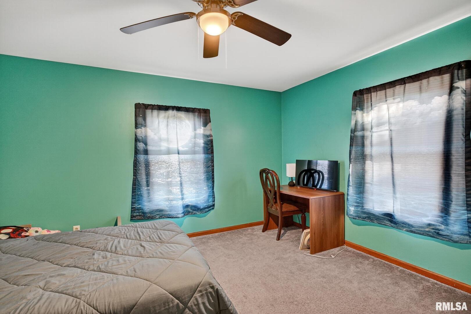 919 9th Avenue Fulton, IL 61252 - Photo 53 of 54 a bed room with a bed and a chandelier