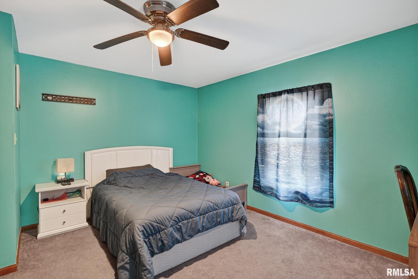 919 9th Avenue Fulton, IL 61252 - Photo 54 of 54 a bedroom with a bed and a chandelier