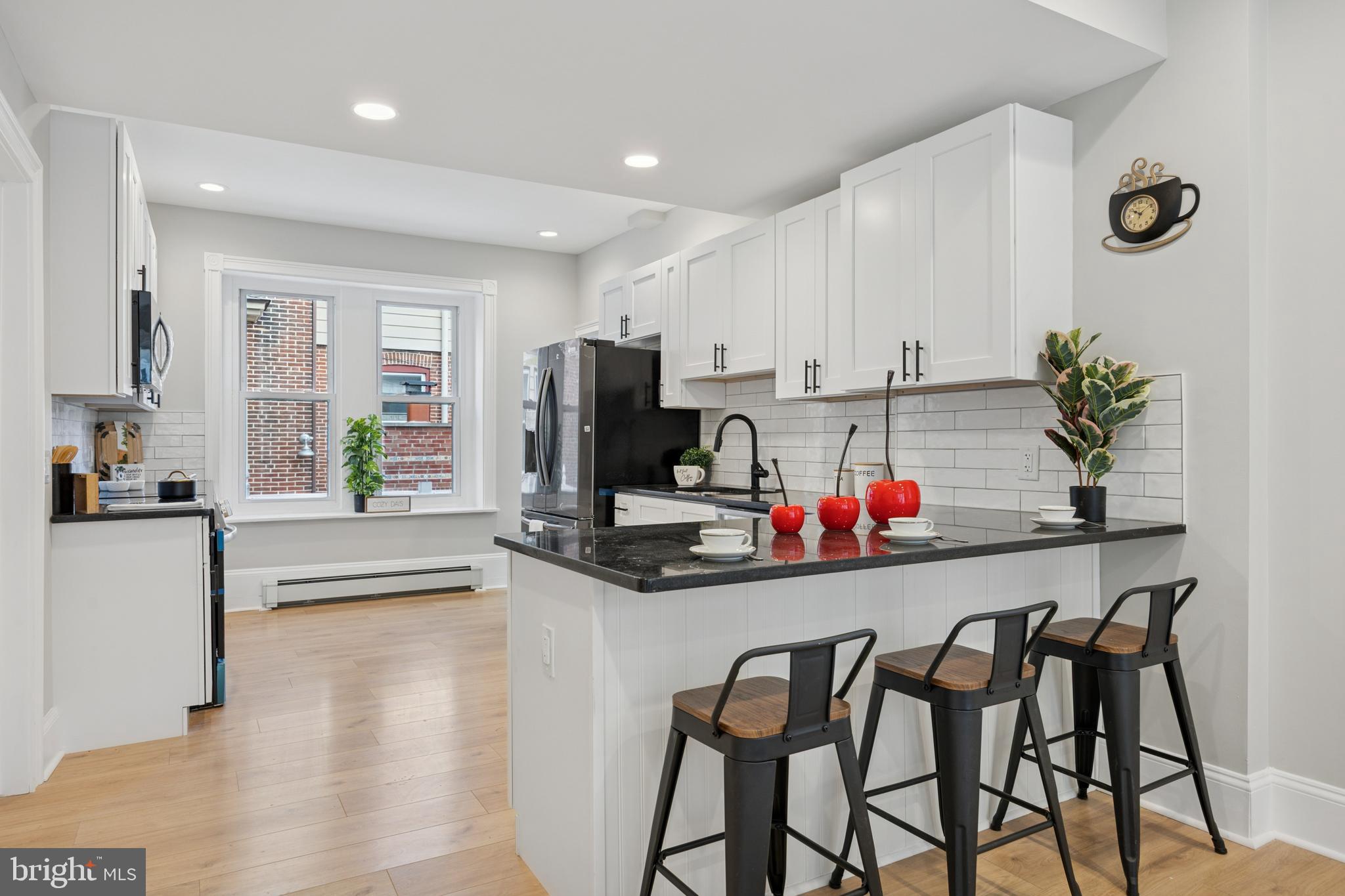 405 North Swarthmore Avenue Ridley Park, PA 19078 - Photo 11 of 35 a kitchen with stainless steel appliances kitchen island granite countertop a refrigerator and microwave