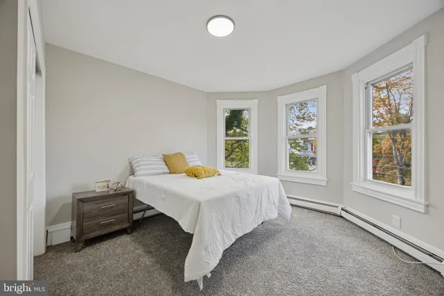 a spacious bedroom with a bed and a window