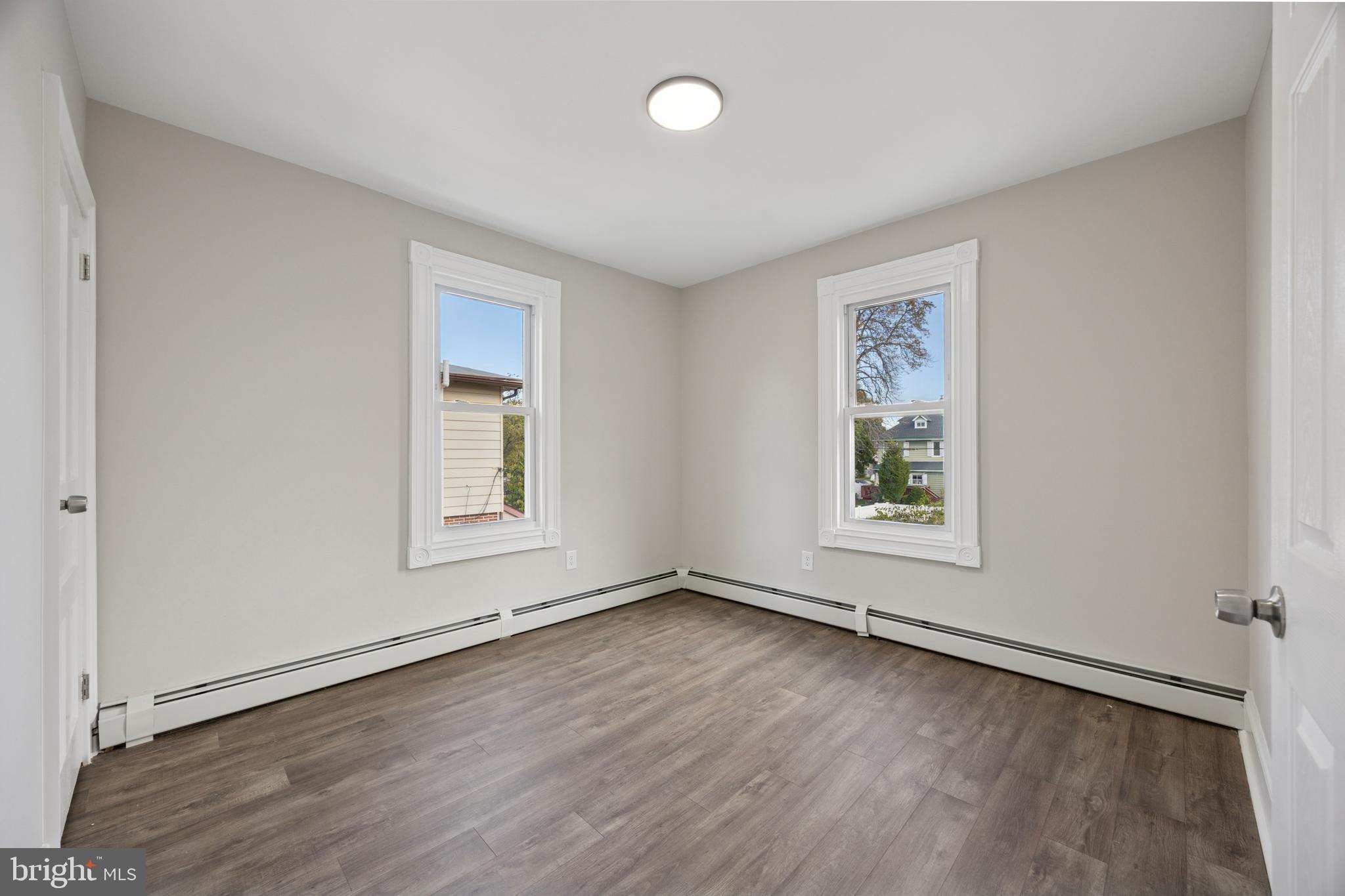 405 North Swarthmore Avenue Ridley Park, PA 19078 - Photo 20 of 35 an empty room with wooden floor and windows