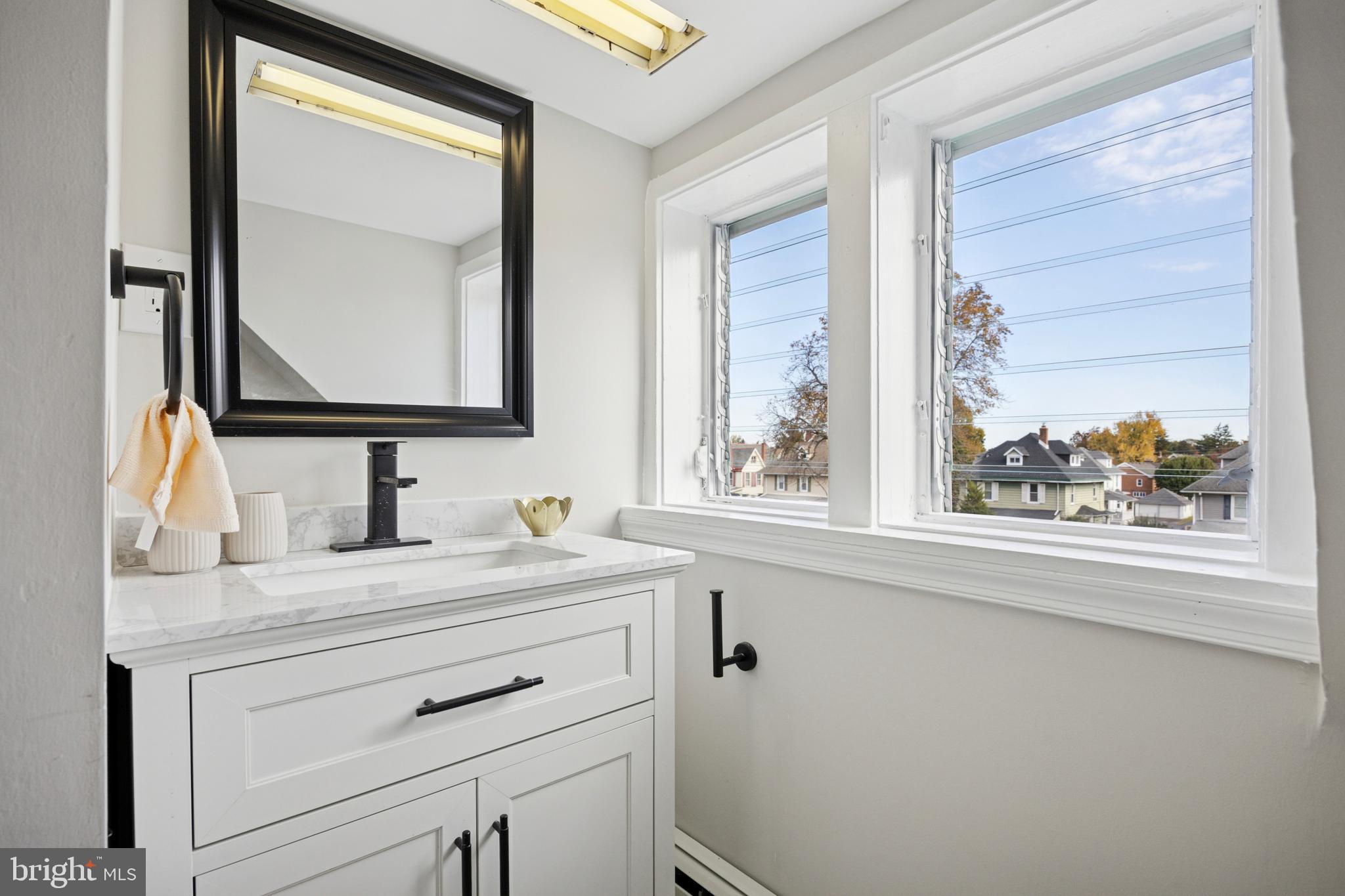 405 North Swarthmore Avenue Ridley Park, PA 19078 - Photo 27 of 35 a bathroom with a sink vanity and a mirror