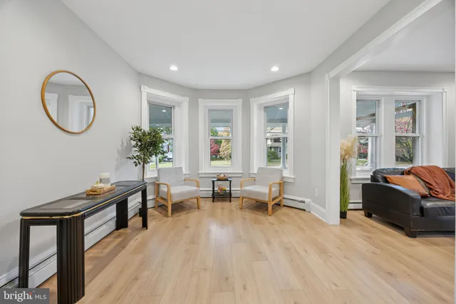a living room with furniture a table and a potted plant