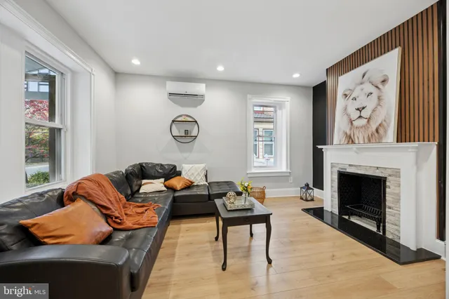 a living room with furniture and a fireplace
