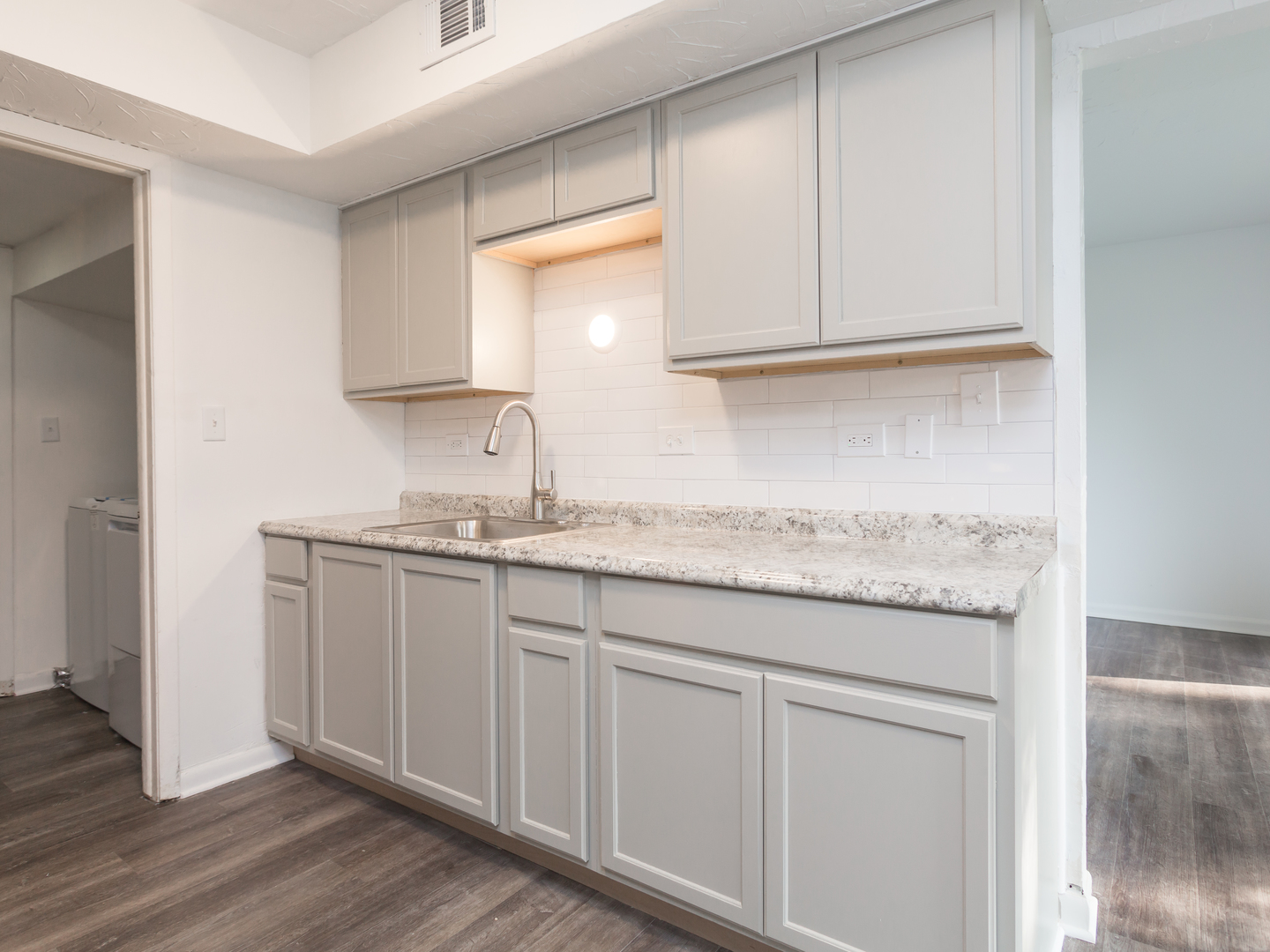 701 Spring Court, Unit 5 University Park, IL 60484 - Photo 5 of 17 a bathroom with granite countertop a sink and a white cabinets