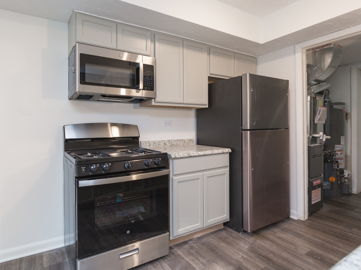 701 Spring Court, Unit 5 University Park, IL 60484 - Photo 6 of 17 a kitchen with a refrigerator stove and wooden cabinets