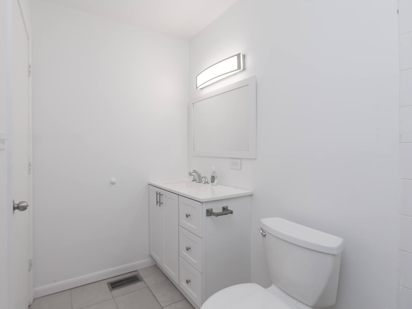 701 Spring Court, Unit 5 University Park, IL 60484 - Photo 8 of 17 a bathroom with a sink a toilet and a mirror